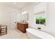 Bathroom features a soaking tub, wooden vanity, and natural light at 1474 Blue Cascade Dr, Mount Pleasant, SC 29464
