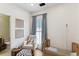 Warm Bedroom showcasing a rocking chair, a baby crib, soft curtains, and stylish decor for a comfortable atmosphere at 1474 Blue Cascade Dr, Mount Pleasant, SC 29464