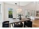 Elegant dining area with natural light, stylish chandelier, and view of the backyard at 1474 Blue Cascade Dr, Mount Pleasant, SC 29464