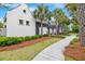 Beautifully landscaped path leading to a modern building with palm trees and manicured bushes at 1474 Blue Cascade Dr, Mount Pleasant, SC 29464