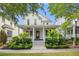 Charming two-story home with a welcoming front porch and manicured landscaping at 1474 Blue Cascade Dr, Mount Pleasant, SC 29464
