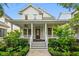 Charming two-story home featuring a welcoming front porch with elegant columns and beautifully landscaped yard at 1474 Blue Cascade Dr, Mount Pleasant, SC 29464