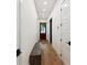 Hallway shows hardwood flooring, a wooden bench, and white walls with black hardware at 1474 Blue Cascade Dr, Mount Pleasant, SC 29464