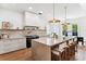 Bright kitchen with marble countertops, large island with bar seating, and modern appliances at 1474 Blue Cascade Dr, Mount Pleasant, SC 29464