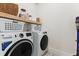 Laundry room equipped with modern washer and dryer, wooden shelf, and plenty of storage space at 1474 Blue Cascade Dr, Mount Pleasant, SC 29464