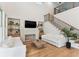 Bright living room features hardwood floors, high ceilings, fireplace, and staircase at 1474 Blue Cascade Dr, Mount Pleasant, SC 29464
