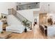 Spacious living room featuring a modern staircase, hardwood floors, and a view into the open kitchen at 1474 Blue Cascade Dr, Mount Pleasant, SC 29464