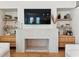 Living room highlights a modern fireplace with built-in shelving and hardwood floors at 1474 Blue Cascade Dr, Mount Pleasant, SC 29464