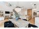 Contemporary living space featuring fireplace, open kitchen, dining room and modern staircase at 1474 Blue Cascade Dr, Mount Pleasant, SC 29464