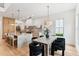 Open living space featuring kitchen, dining area and living room with hardwood floors and large windows at 1474 Blue Cascade Dr, Mount Pleasant, SC 29464