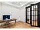 Bright office with hardwood floors, a desk with a computer, and modern french doors at 1474 Blue Cascade Dr, Mount Pleasant, SC 29464