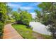 Scenic pond view with a wooden boardwalk, surrounded by lush greenery and trees at 1474 Blue Cascade Dr, Mount Pleasant, SC 29464