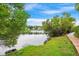 Scenic pond view with lush landscaping, walking path, and charming homes in the background at 1474 Blue Cascade Dr, Mount Pleasant, SC 29464