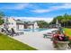 Community pool area with lounge chairs, umbrellas, and well-maintained landscaping at 1474 Blue Cascade Dr, Mount Pleasant, SC 29464