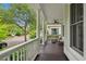 Inviting front porch with seating, fan, and views of the charming neighborhood street at 1474 Blue Cascade Dr, Mount Pleasant, SC 29464