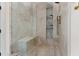 Modern shower featuring a bench seat, tiled walls, and built-in shelving for a luxurious bathroom experience at 1474 Blue Cascade Dr, Mount Pleasant, SC 29464