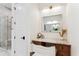 Bathroom vanity with a marble countertop, mirror, and a view of a shower, filled with natural light at 1474 Blue Cascade Dr, Mount Pleasant, SC 29464