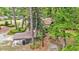 Aerial view showing mature trees surrounding the house and the detached car port at 205 Woodlawn St, Walterboro, SC 29488