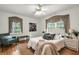 Cozy bedroom features hardwood floors, two windows, and soft, neutral colors at 205 Woodlawn St, Walterboro, SC 29488