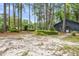 View of home exterior featuring mature trees and shrubs at 205 Woodlawn St, Walterboro, SC 29488