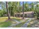 A beautiful view of the exterior of this home, surrounded by large trees and greenery at 205 Woodlawn St, Walterboro, SC 29488