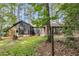 Charming exterior featuring a charcoal grey finish, brick foundation, and natural wood accent, surrounded by mature trees at 205 Woodlawn St, Walterboro, SC 29488
