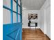 Bright foyer with hardwood floors, console table, white walls, and a view of a brightly painted blue front door at 205 Woodlawn St, Walterboro, SC 29488