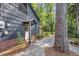 View of covered entrance to the home, with brick foundation, shingle siding, and a path to the front door at 205 Woodlawn St, Walterboro, SC 29488