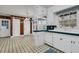 Nostalgic white kitchen featuring green tiled countertops and black and white checkered flooring at 205 Woodlawn St, Walterboro, SC 29488