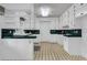 Spacious kitchen with white cabinetry, vintage tile countertops, and open shelving at 205 Woodlawn St, Walterboro, SC 29488