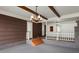 Open space with a unique lighting fixture, brick trim and door to another space at 205 Woodlawn St, Walterboro, SC 29488