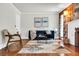 Living room with hardwood floors, a blue sofa, and art enhancing the space's aesthetic at 205 Woodlawn St, Walterboro, SC 29488