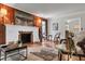 Inviting living room with a decorative fireplace, wood paneling, and hardwood floors at 205 Woodlawn St, Walterboro, SC 29488