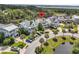 Stunning aerial view of home showcasing its lagoon frontage, lush landscaping, and charming curb appeal at 2072 Amenity Park Dr, Mount Pleasant, SC 29466
