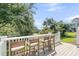 Relaxing back porch with comfortable seating, a white railing, and lush views at 2072 Amenity Park Dr, Mount Pleasant, SC 29466
