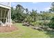 Lush backyard with seating area near scenic wooded area with palm trees in a private oasis at 2072 Amenity Park Dr, Mount Pleasant, SC 29466
