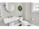 Cozy bathroom with a pedestal sink, toilet, and decorative wreath, perfect for guests at 2072 Amenity Park Dr, Mount Pleasant, SC 29466