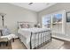 Cozy bedroom features a black metal bedframe, wood floors, and sun-filled windows at 2072 Amenity Park Dr, Mount Pleasant, SC 29466