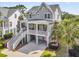 Charming coastal home featuring a covered porch, double staircase, and lush landscaping at 2072 Amenity Park Dr, Mount Pleasant, SC 29466