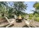 Charming outdoor fire pit area with four Adirondack chairs surrounded by lush greenery at 2072 Amenity Park Dr, Mount Pleasant, SC 29466