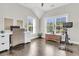 Bright home office featuring hardwood floors, large windows, and white desk with a wicker chair at 2072 Amenity Park Dr, Mount Pleasant, SC 29466