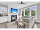 Comfortable living room with fireplace, ceiling fan, and large windows at 2072 Amenity Park Dr, Mount Pleasant, SC 29466