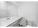 Bright bathroom with a modern sink, white countertop, and large mirror, accented by white walls and flooring at 208 Cache Ct, Charleston, SC 29414