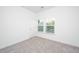 Bedroom with neutral carpet, white walls, a window, and a white door, offering a blank canvas at 208 Cache Ct, Charleston, SC 29414