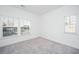 Bedroom showcasing neutral carpet, white walls, and large windows with outside views at 208 Cache Ct, Charleston, SC 29414