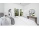 Inviting bedroom featuring a large window, white bedding, and accent furniture at 208 Cache Ct, Charleston, SC 29414