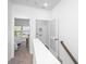 Bright hallway featuring neutral carpet and white walls, leading to a bedroom and the laundry closet at 208 Cache Ct, Charleston, SC 29414