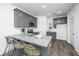 Modern kitchen featuring gray cabinets, granite countertops, and a functional breakfast bar at 208 Cache Ct, Charleston, SC 29414