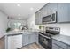 Well-equipped kitchen with stainless steel appliances and gray cabinetry at 208 Cache Ct, Charleston, SC 29414