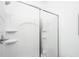 Contemporary walk-in shower with clear glass doors and white tiled walls at 208 Cache Ct, Charleston, SC 29414